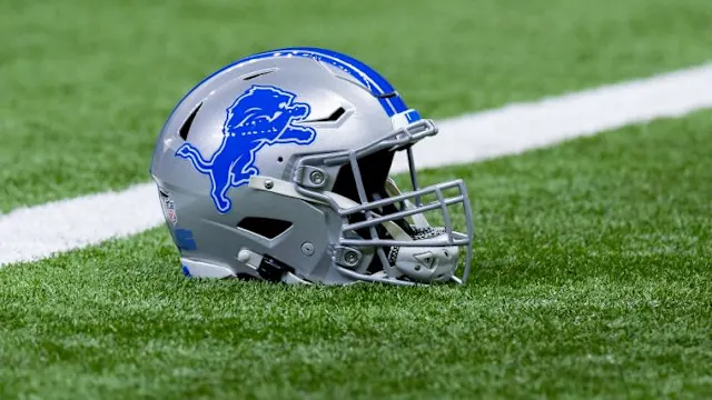 The Lions helmet laying on the grass.
